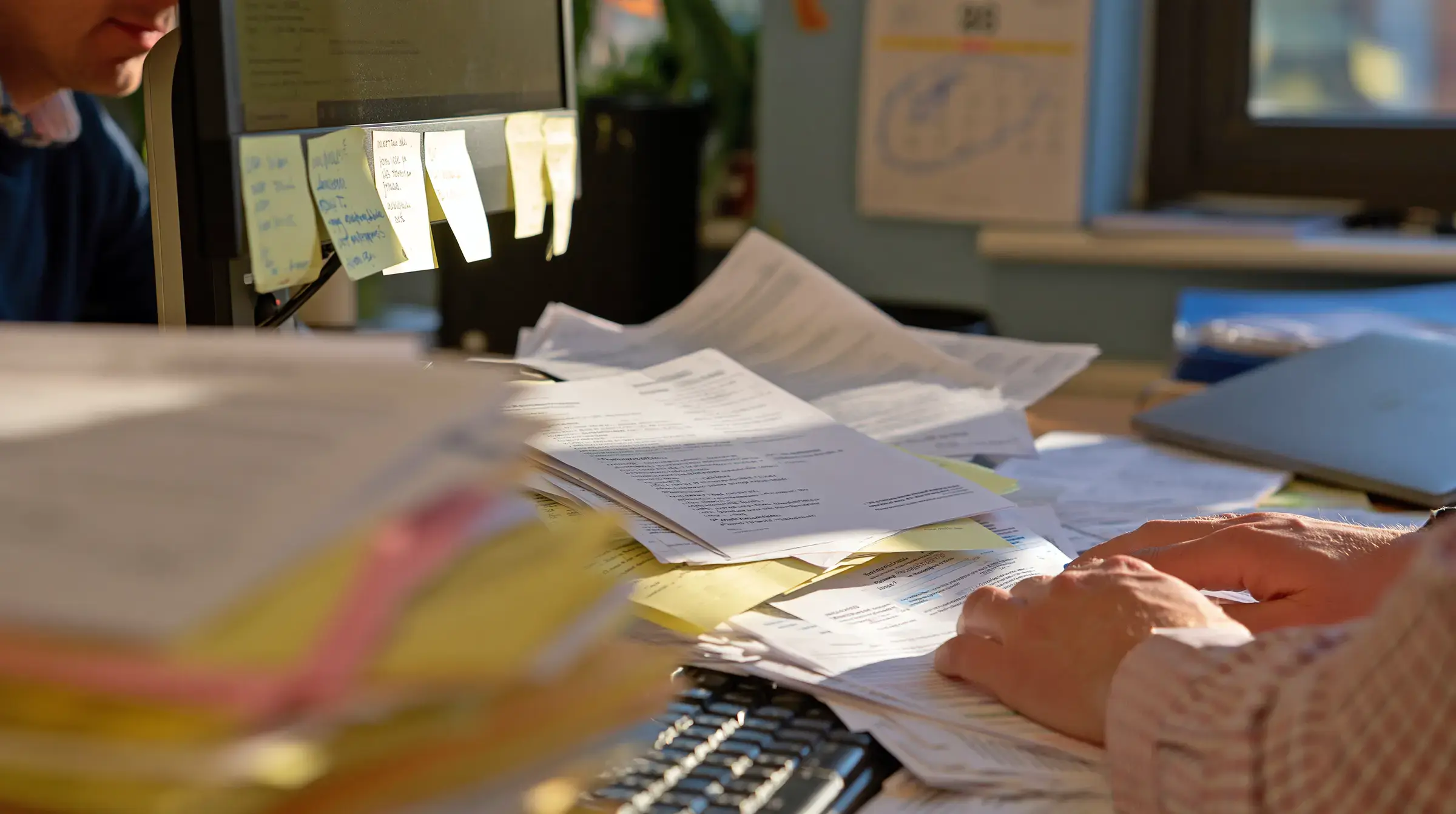 Stacks of paper case files – the manual workload Fisar removes